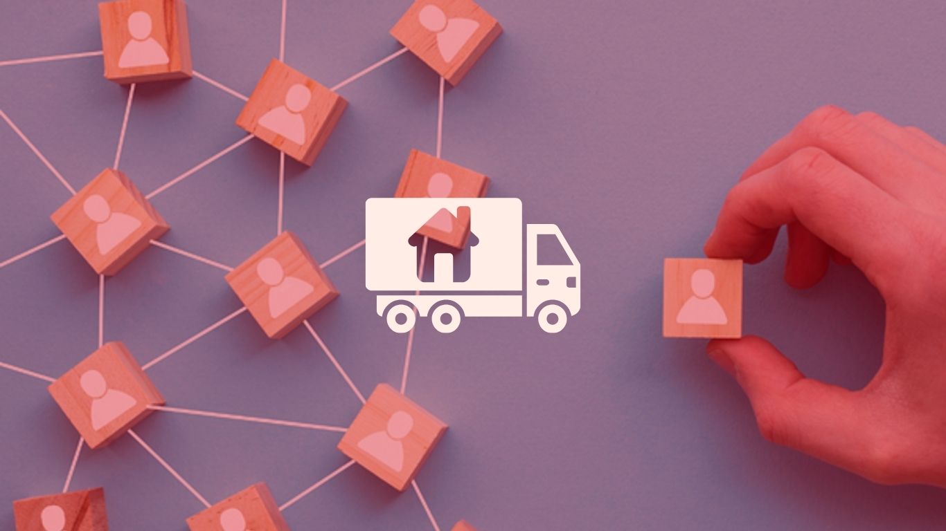 a hand holding wooden blocks with a truck and people icons